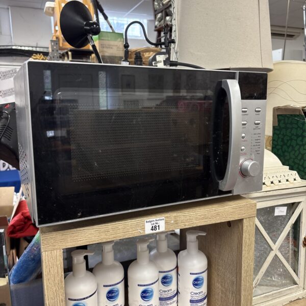 Black Dunelm microwave appliance on a neutral background.