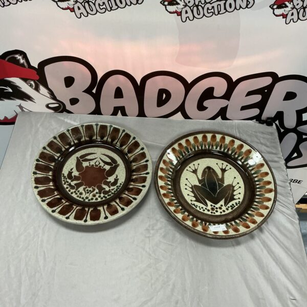 Two vintage earthenware glazed plates with floral designs.