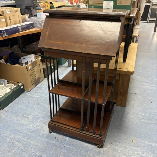 Antique Edwardian mahogany revolving bookcase with tiered shelves.