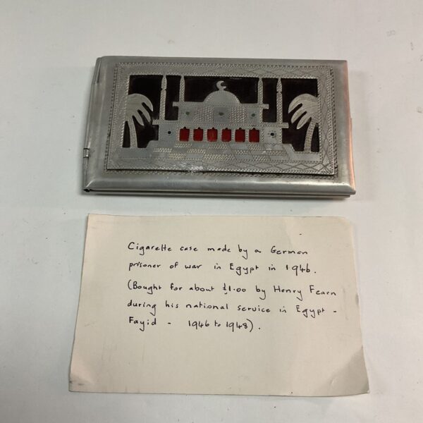 Vintage Egyptian cigarette case crafted by a POW, featuring embossed architecture.