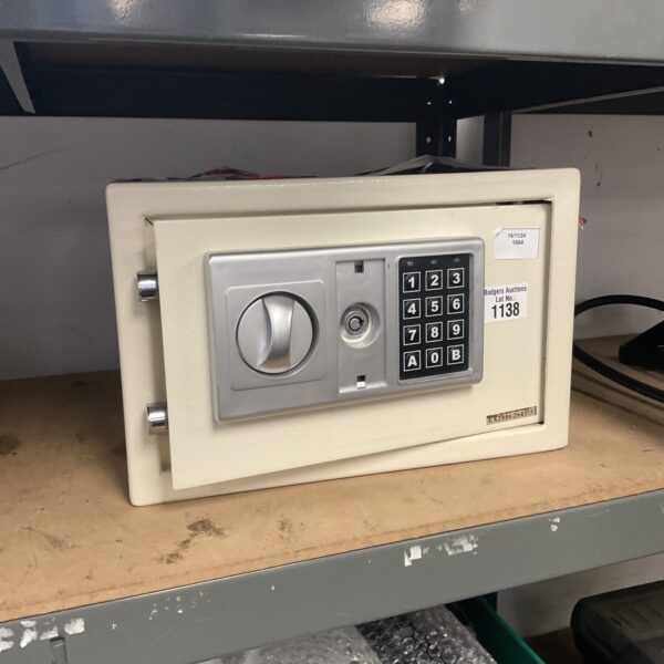 Front view of a vintage electric personal safe with a keypad.