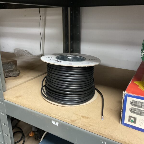 Partially used reel of flat, two-core electrical cable for wiring projects.