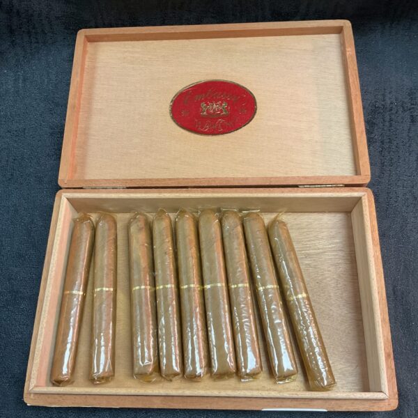 Open view of a vintage Embassy cigars box with nine cellophane-wrapped cigars.