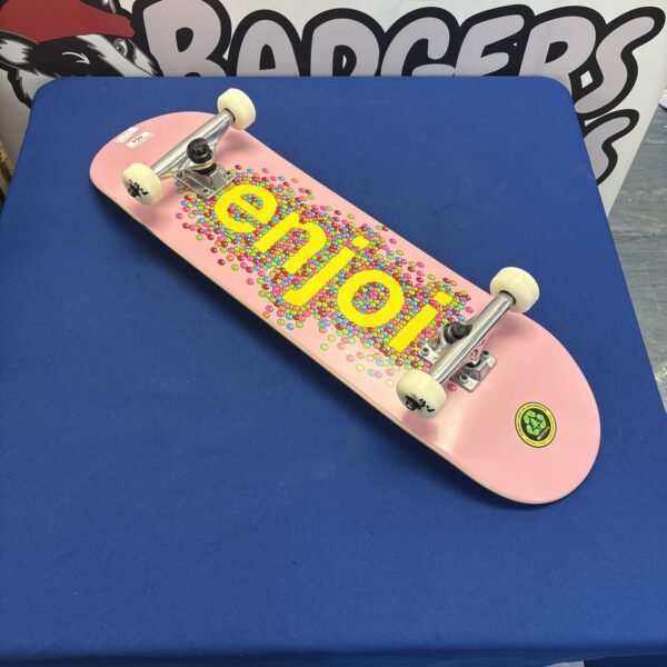 Pink Enjoi skateboard with Tensor trucks, complete setup for street skating.