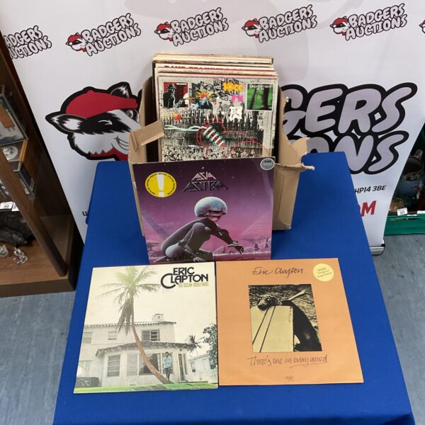 Eric Clapton LP collection of vinyl records on a table.