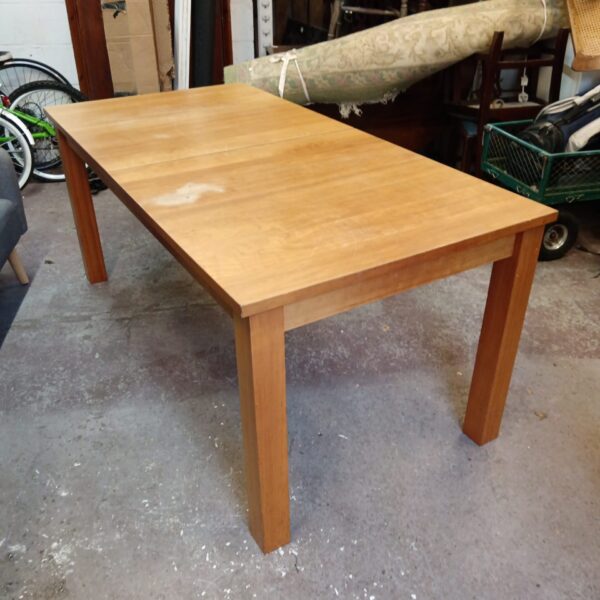 Large extending oak dining table in a domestic setting.