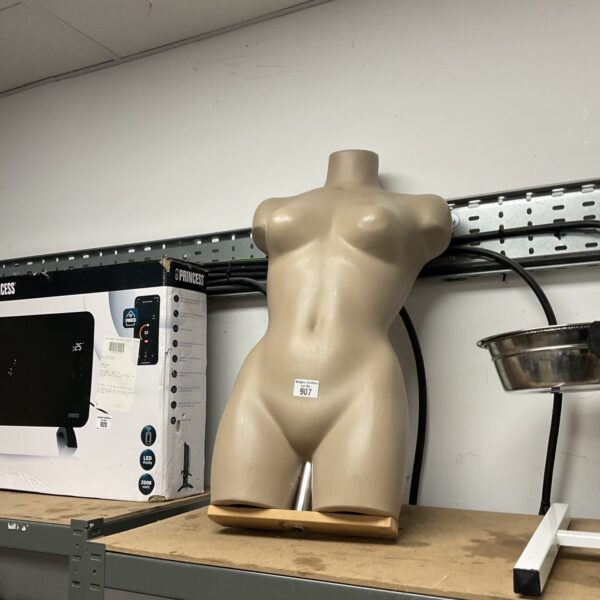 Vintage female mannequin torso for clothing display.