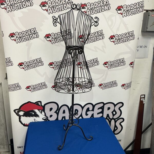 Vintage female metal mannequin for clothing display.