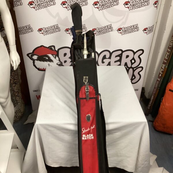 Bundle of fishing rods with a large fishing umbrella for angling.