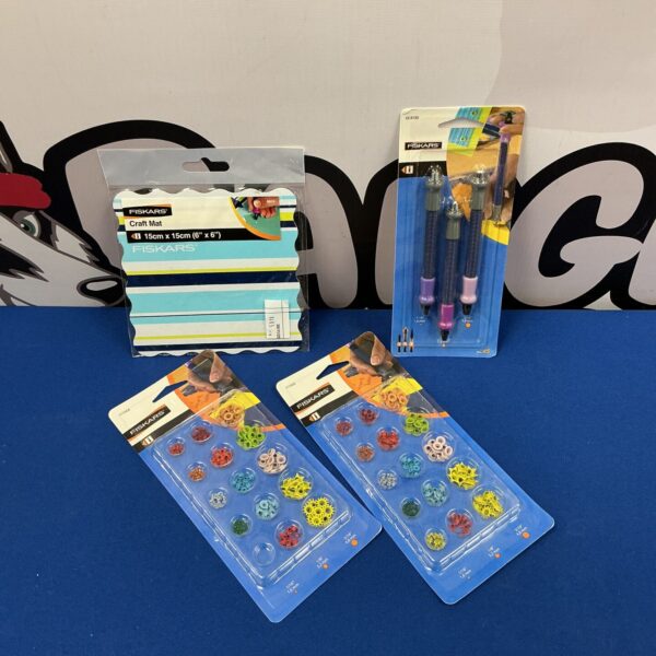 Fiskars craft bundle with punches, mat, and eyelets for DIY projects.