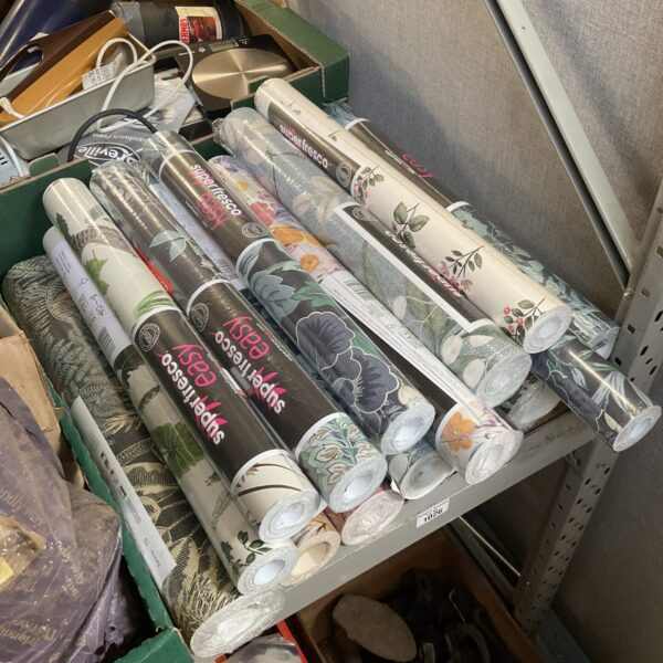 Large lot of unused floral patterned wallpaper rolls for home decor.