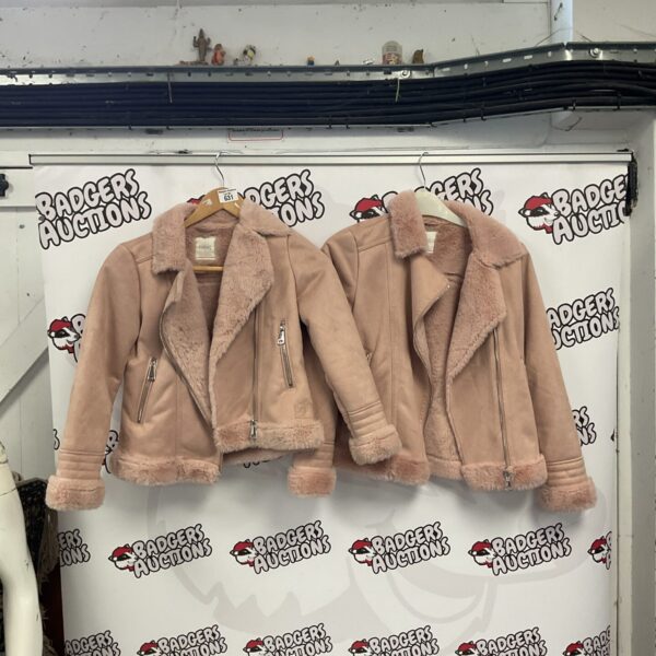 Two small fluffy children's coats for winter wear.