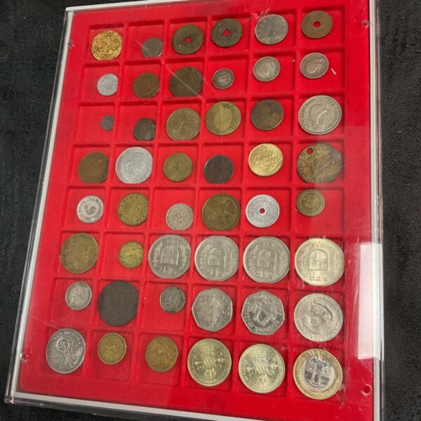 Tray of assorted foreign coins for collectors.