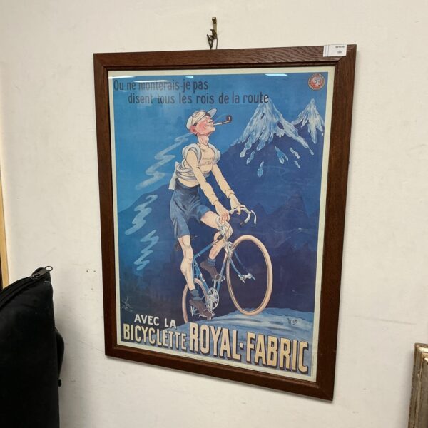 Vintage French cycling poster with a cyclist and mountainous backdrop.