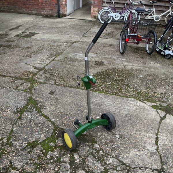 Green garden pot trolley with yellow wheels for moving plants.