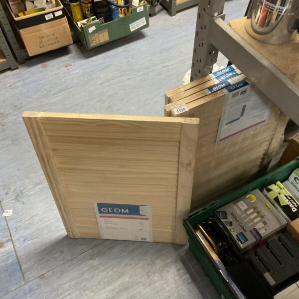 New Geom pine louvre doors stacked and wrapped in plastic.