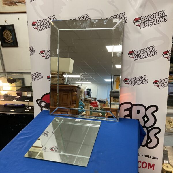 Two geometric frameless mirrors with a mid-century modern aesthetic.