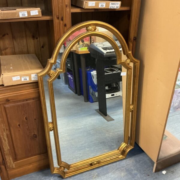 Ornate gilt framed hall mirror with detailed carving.