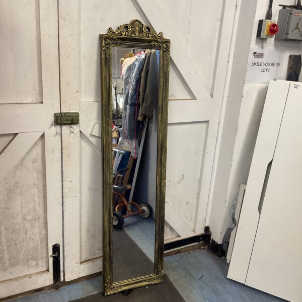 Ornate gilt framed hall mirror with detailed moulding.