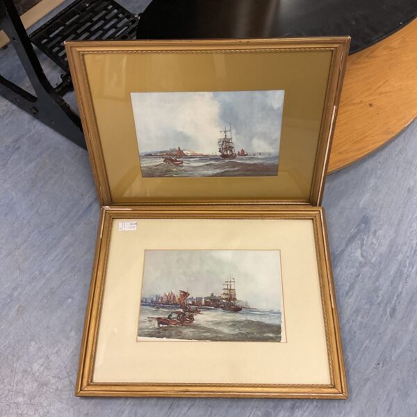 Vintage gilt-framed nautical ship prints depicting sailing vessels.