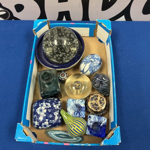 Colourful glass paperweight collection on display.
