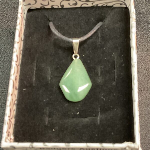 Vibrant green jade pendant necklace on a rope chain.