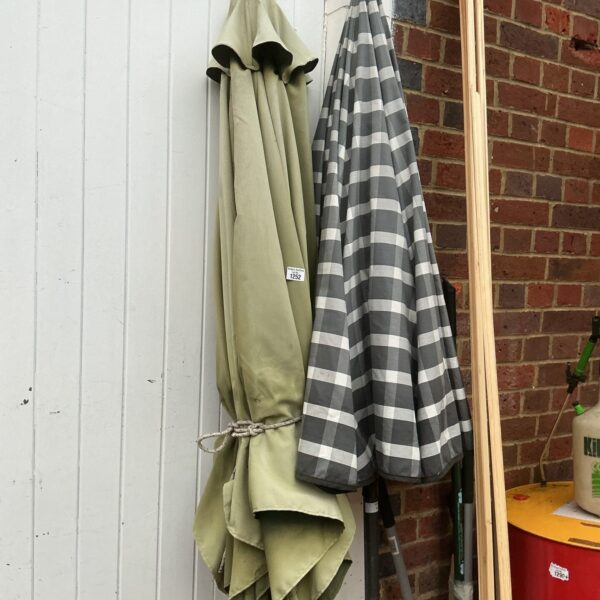 Green striped garden parasol in used condition.