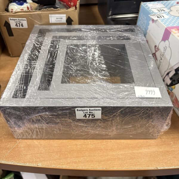 Set of three grey floating shelves with fittings for wall mounting.