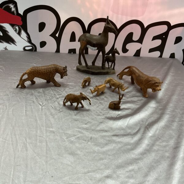 Collection of hand-carved wooden animals in folk art style.