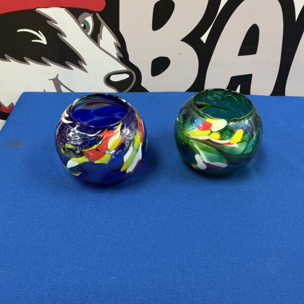 Vibrant handblown glass pots with colourful swirls.