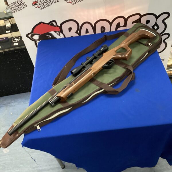 Hatsan air rifle with scope and accessories for shooting sports.