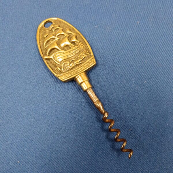 Vintage brass HMS Victory corkscrew, detailed nautical design.