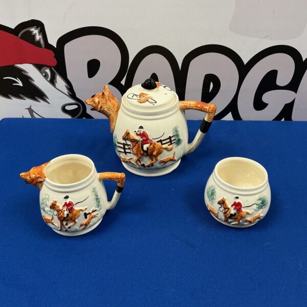 Vintage horse and hounds tea set with detailed porcelain scenes.