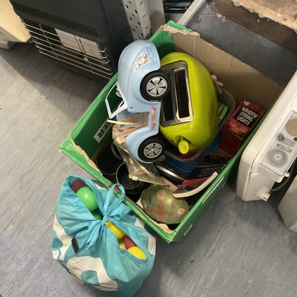 House clearance lot with vintage toys and a toaster.