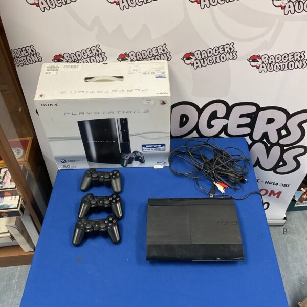 Sony Playstation 3 slim console with three remotes and Playstation 3 box