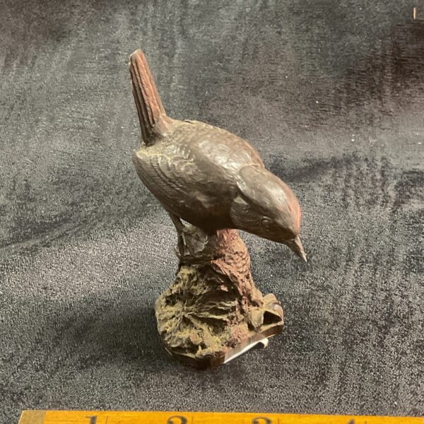 Vintage iron wren sculpture with bronzed finish on rocky base.