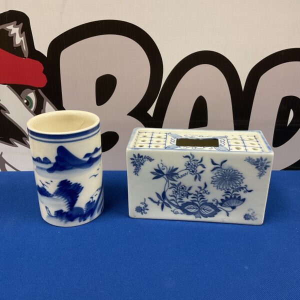 Antique Japanese blue and white porcelain brush pots with floral designs.