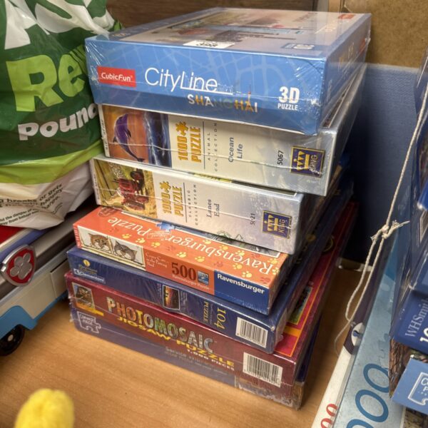 Sealed jigsaw puzzle bundle including Ravensburger and other brands.