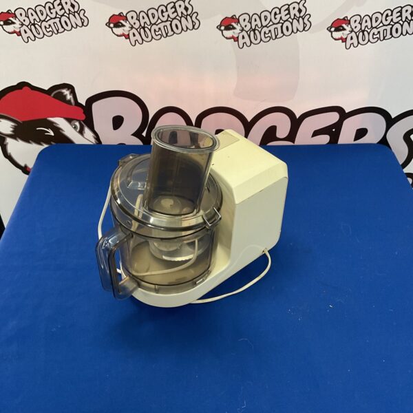 Silver Kenwood gourmet food processor for kitchen food preparation.