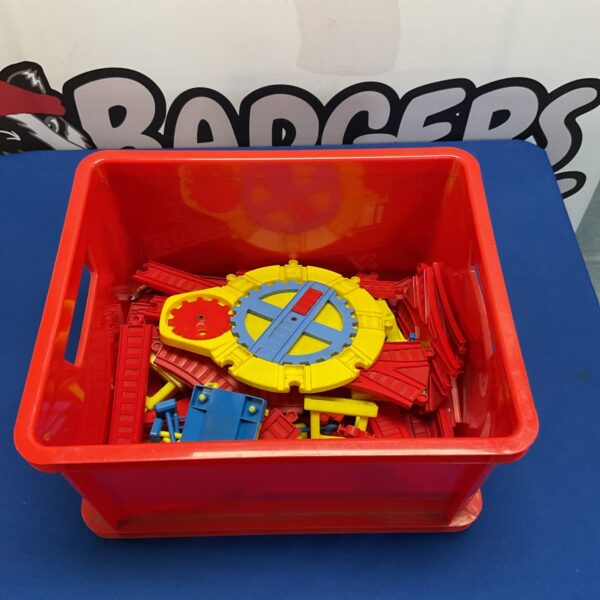 Colourful kids train set with railway components in a plastic box.