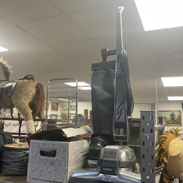 Front view of a vintage Kirby G4 vacuum cleaner with attachments.