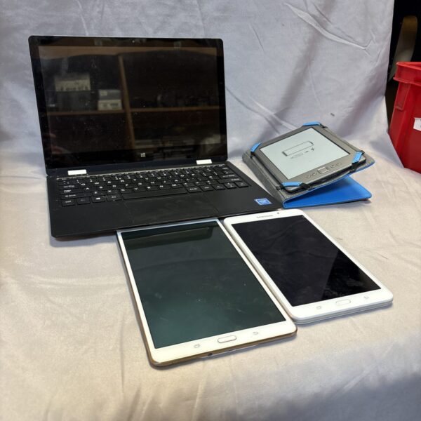 Bundle of used laptop, tablets, and Kindle e-reader for sale.