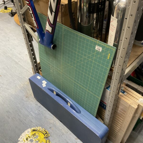 Large blue cutting mat with carrying case for crafting.