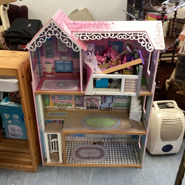 Large vintage dolls house with detailed rooms and furniture.