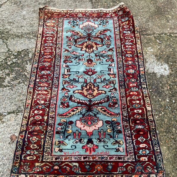 Large handwoven Turkish rug with intricate floral and geometric patterns.