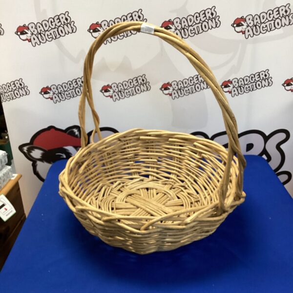 Large woven basket with handles, ideal for farmhouse storage.