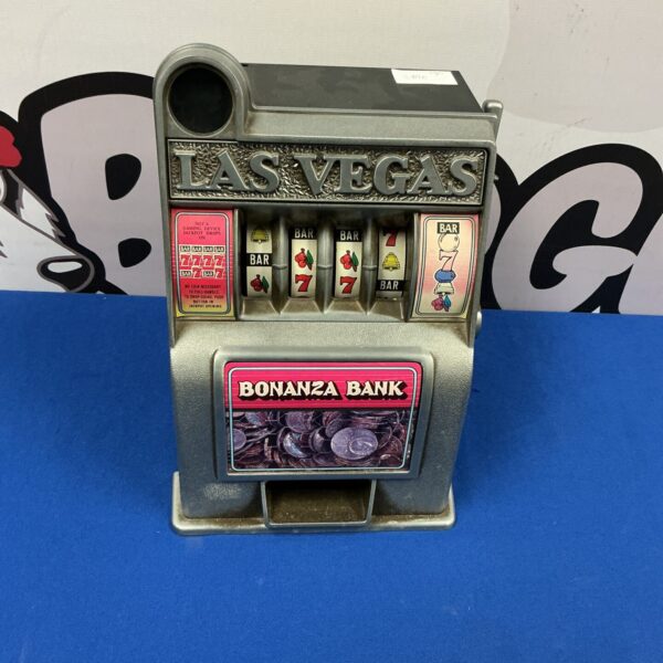 Vintage Las Vegas slot machine bank with lever and colourful graphics.
