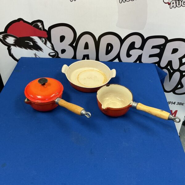 Vibrant orange Le Creuset casserole dish with lid and handles.