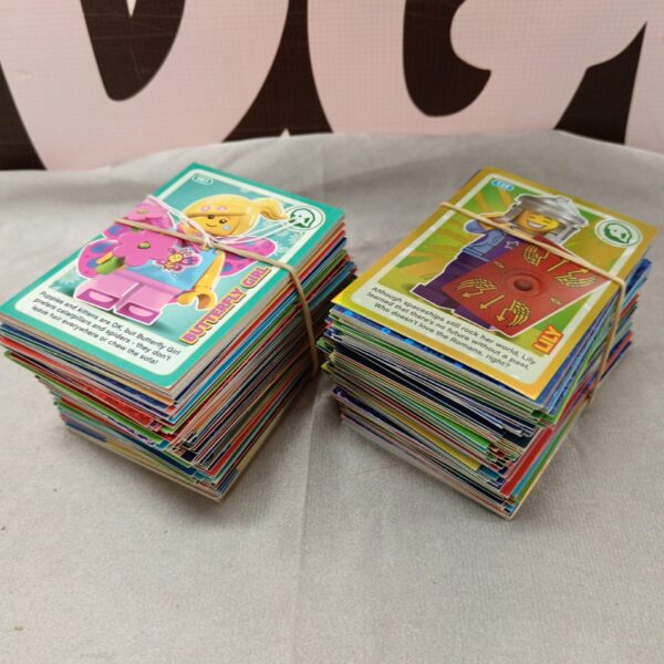 Lego trading cards in a pile, collectible card lot.