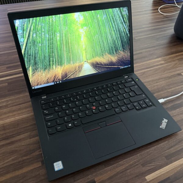 Open Lenovo ThinkPad T470s laptop displaying bamboo forest wallpaper.